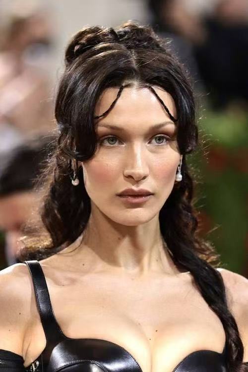 Bella Hadid romantic updo hairstyle with face framing tendrils
