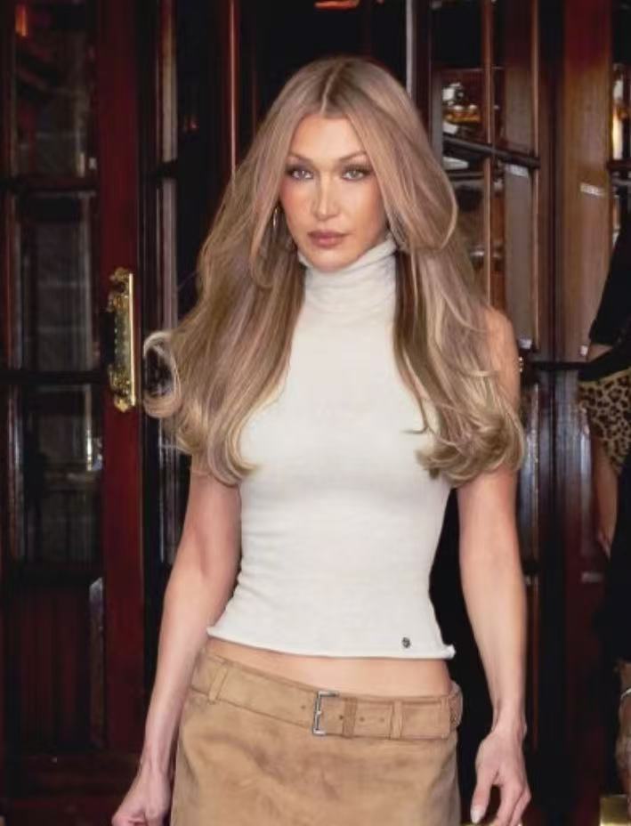 Bella Hadid long blonde layered hairstyle with soft blowout