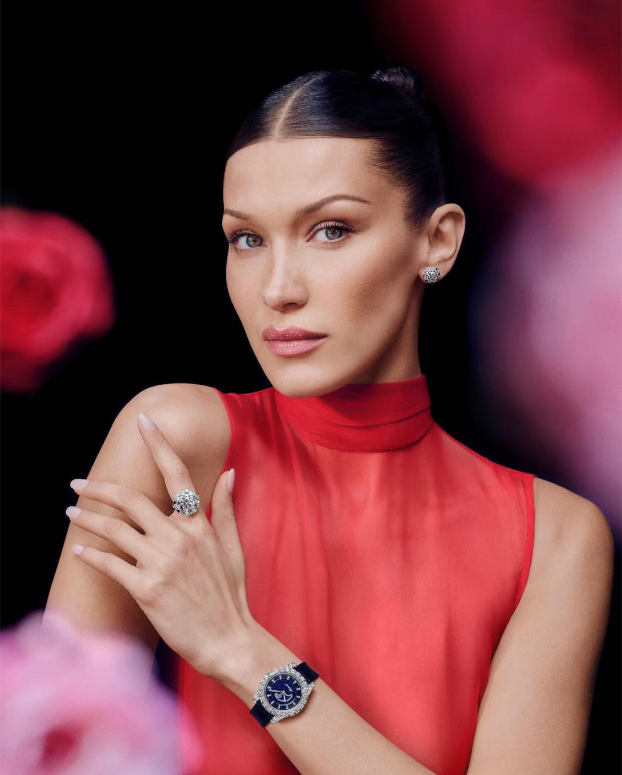 Bella Hadid glossy center part hairstyle with sleek low bun