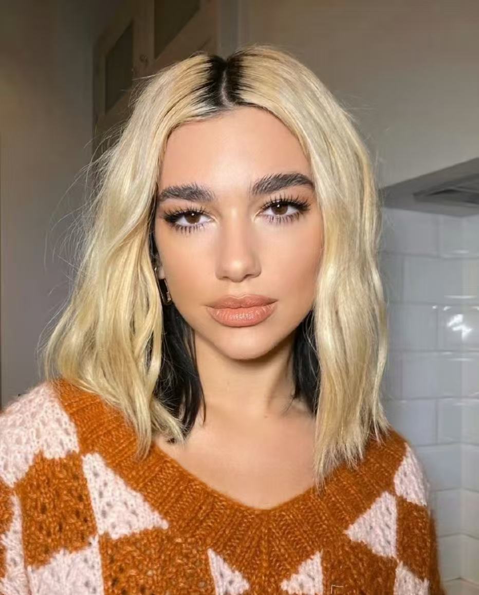 Dua Lipa two tone blonde hairstyle with dark underlayer