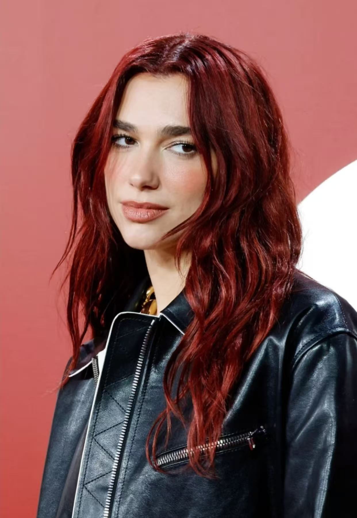 Dua Lipa cherry red long wavy hairstyle