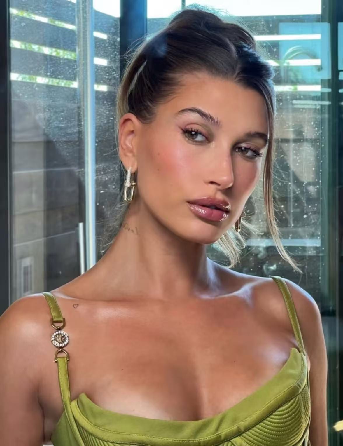 Hailey Bieber inspired clean girl slick bun with glowing minimal styling