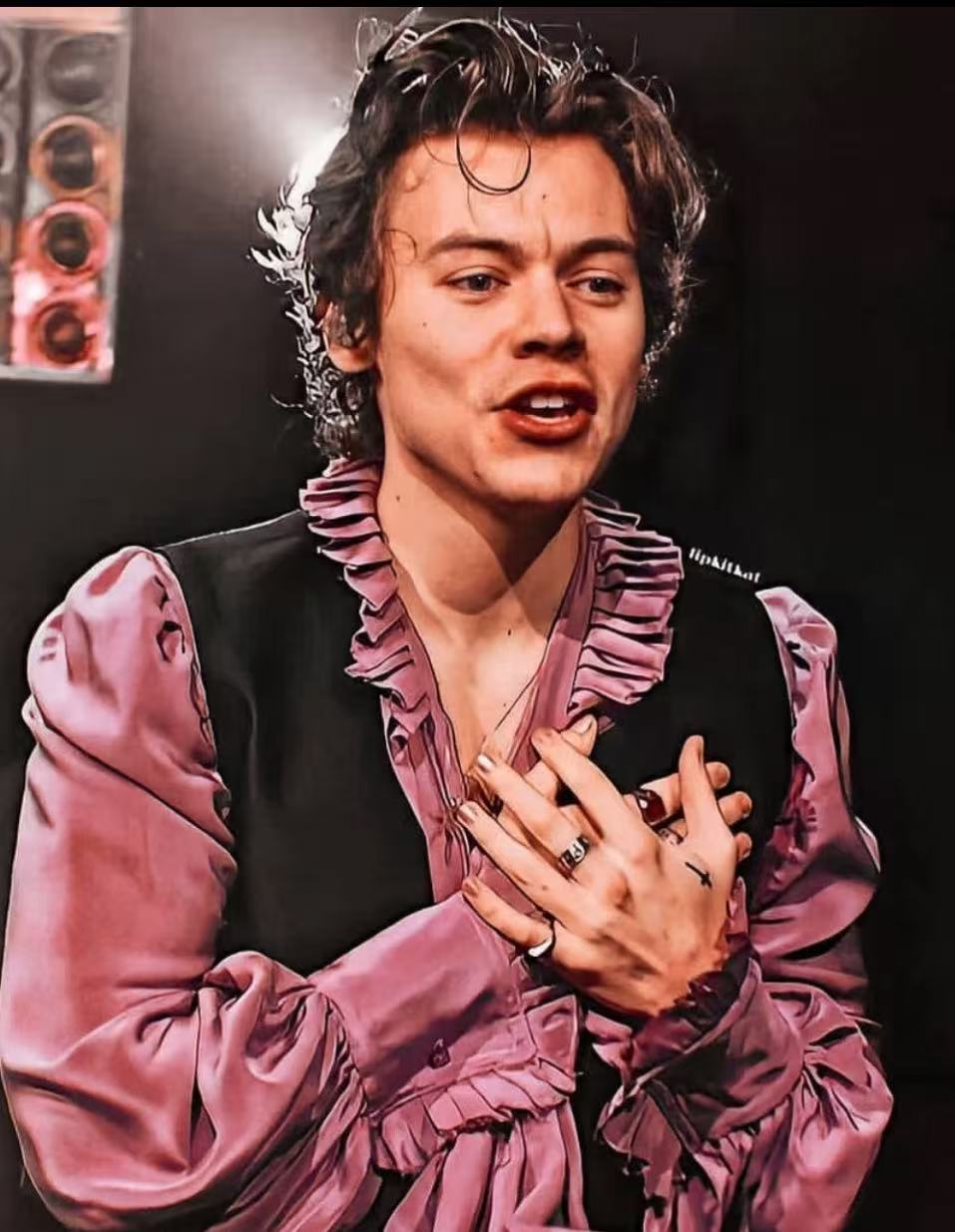 Harry Styles wet look curly hairstyle with pink ruffled shirt