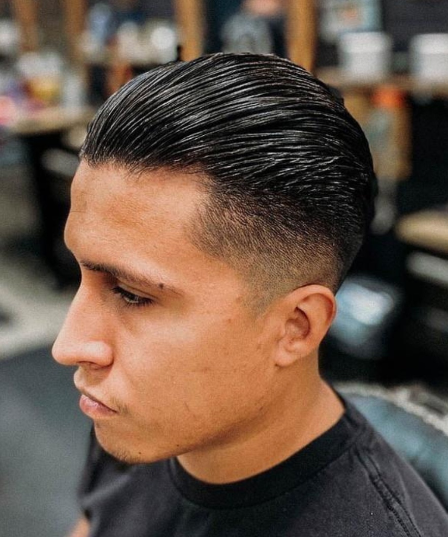 Classic slick back haircut with clean faded sides