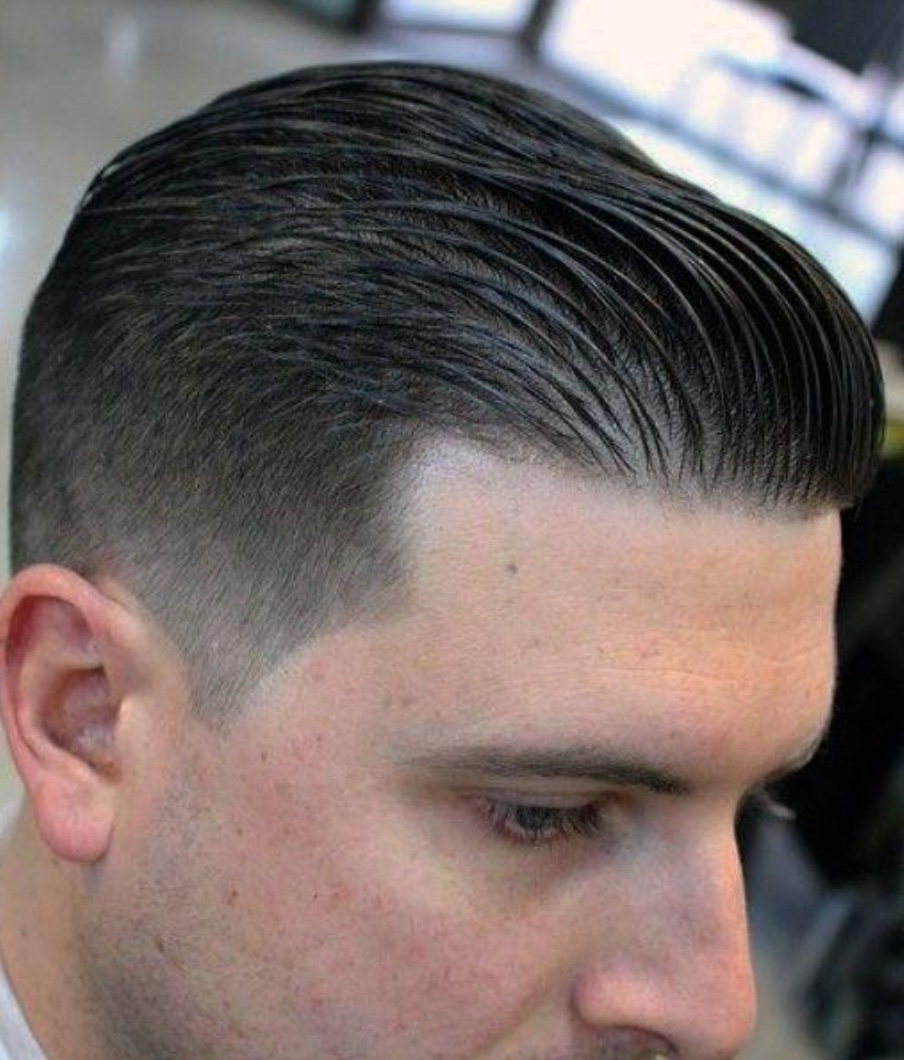 Wet look slick back hairstyle with structured comb lines